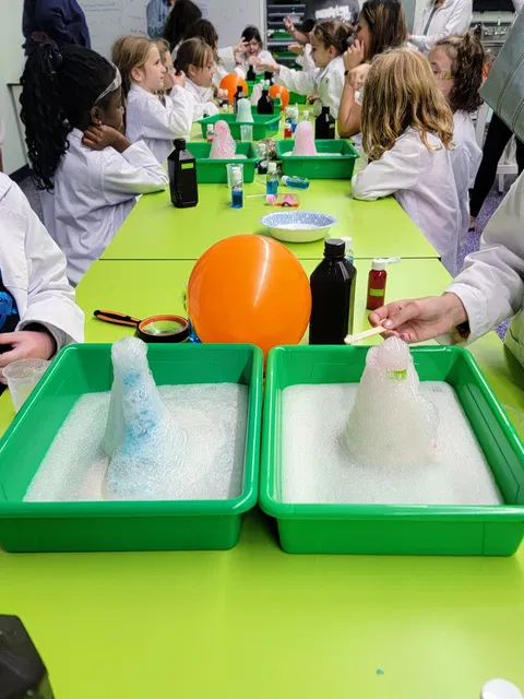 Kids watching exciting volcano experiment at Reaction Lab