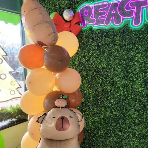 Capybara balloons beside the Reaction Lab sign
