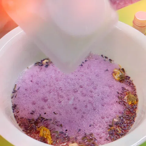 Purple bubbling potion in a white bowl