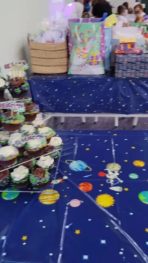 Space-themed party table with cupcakes